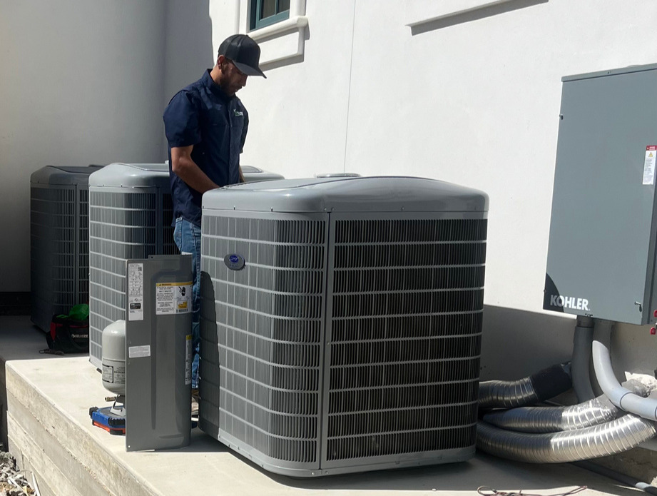 employee working on an air conditioning unit